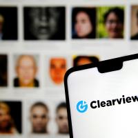 Clearview AI logo with facial images in the background