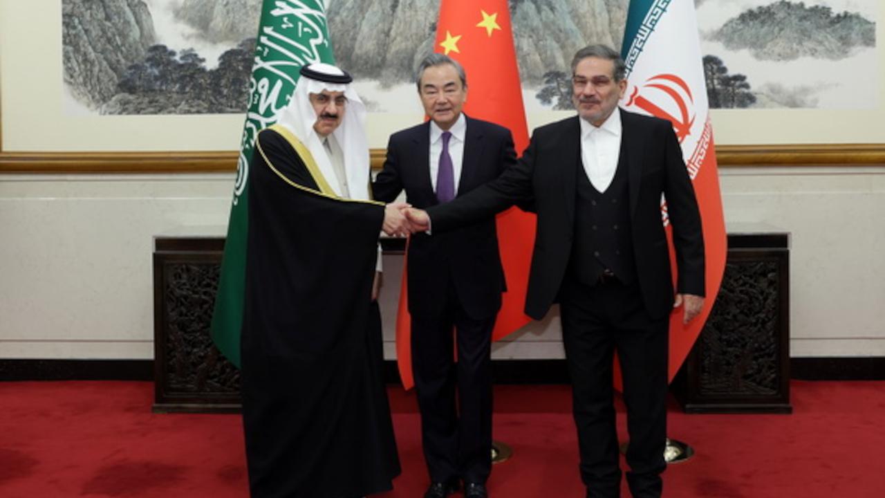 Saudi, Chinese, and Iranian diplomats shaking hands
