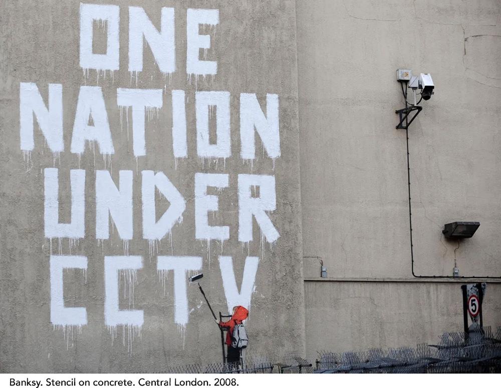 Banksy stencil on a concrete wall that says "One Nation Under CCTV". London. 2008.